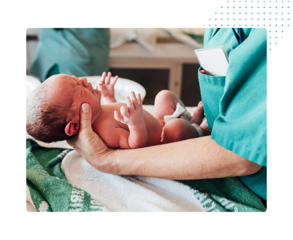 nurse holding newborn baby