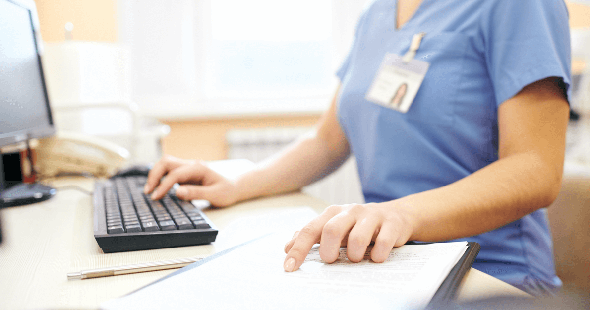Medical professional working on a keyboard - HealthStream Performance &amp; Engagement